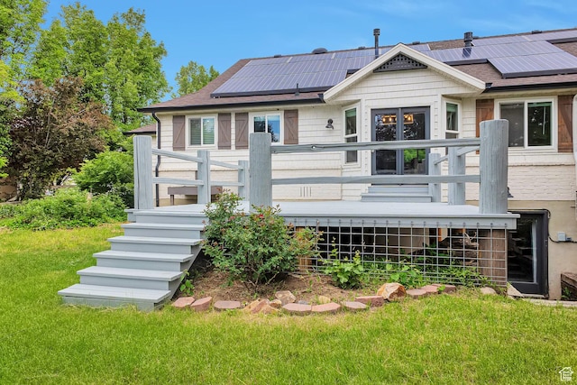 2101 W 325 S, Mapleton, UT 84664 - rear view of house with a lawn, roof mounted solar panels, a deck, and roof with shingles