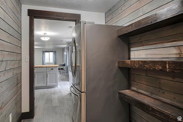 2101 W 325 S, Mapleton, UT 84664 - kitchen featuring wooden walls, freestanding refrigerator, light wood-type flooring, butcher block counters, and a textured ceiling
