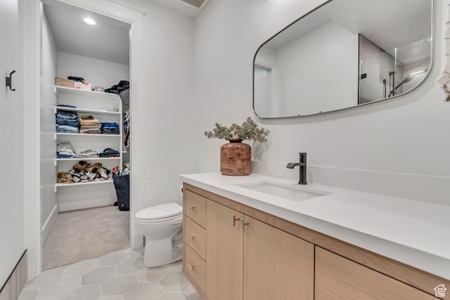 1366 S 370 E, Salem, UT 84653 - bathroom featuring vanity, a walk in closet, toilet, tile patterned flooring, and a shower