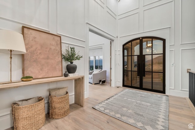 1366 S 370 E, Salem, UT 84653 - entrance foyer featuring arched walkways, wood finished floors, a high ceiling, a decorative wall, and french doors