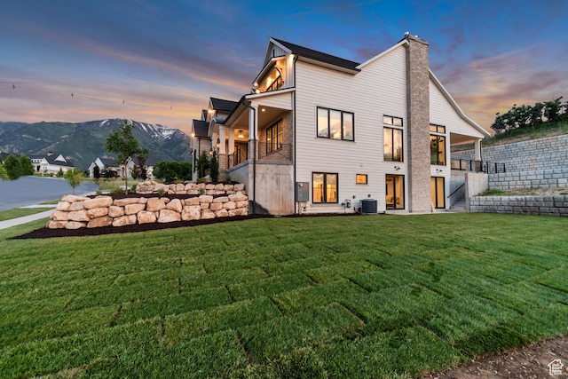 1366 S 370 E, Salem, UT 84653 - back of house at dusk with a yard, central air condition unit, a chimney, a balcony, and a mountain view