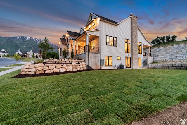 1366 S 370 E, Salem, UT 84653 - back of property at dusk with a yard, central air condition unit, stairs, a balcony, and a chimney