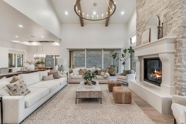 1366 S 370 E, Salem, UT 84653 - living room with a chandelier, a towering ceiling, light wood finished floors, a large fireplace, and beamed ceiling