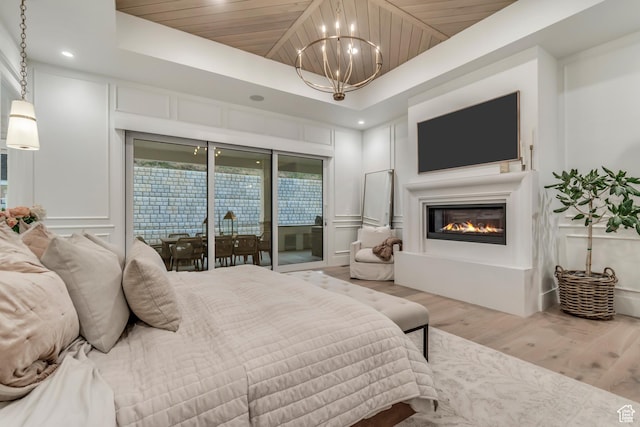1366 S 370 E, Salem, UT 84653 - bedroom featuring wood finished floors, a chandelier, access to exterior, wooden ceiling, and a glass covered fireplace