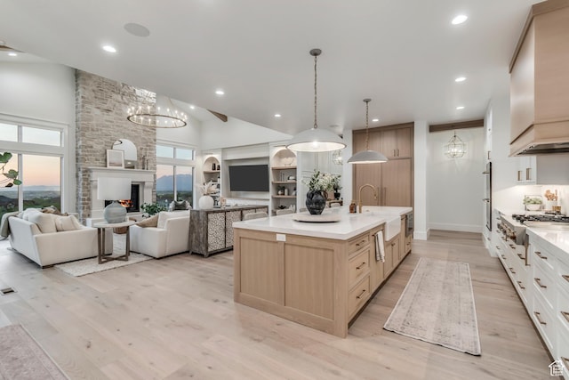 1366 S 370 E, Salem, UT 84653 - kitchen with a sink, stainless steel gas cooktop, light wood-style floors, high vaulted ceiling, and a kitchen island with sink