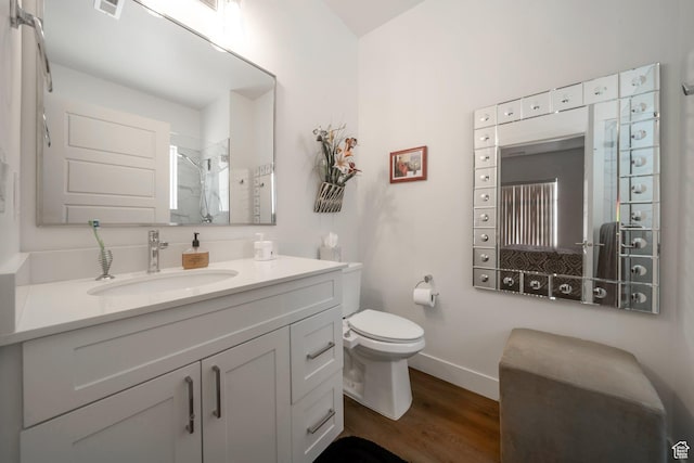3610 S 805 E Unit 233, Millcreek, UT 84106 - bathroom featuring wood finished floors, tiled shower, toilet, baseboards, and vanity