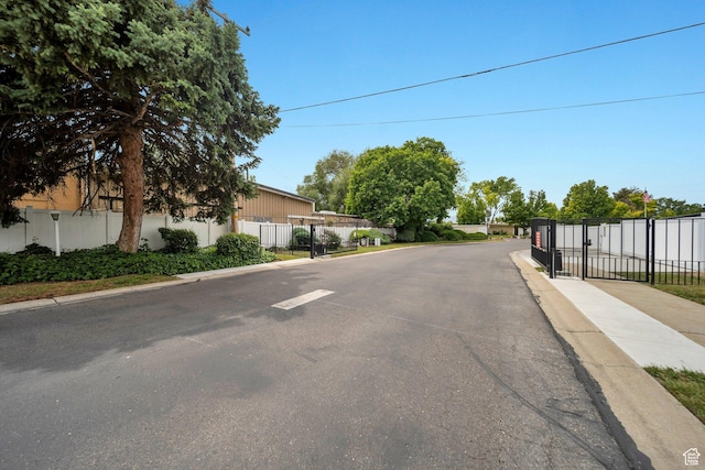 3610 S 805 E Unit 233, Millcreek, UT 84106 - view of asphalt road featuring curbs, a gate, and sidewalks