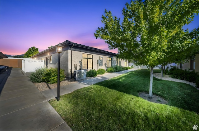 3610 S 805 E Unit 233, Millcreek, UT 84106 - view of front of property with ac unit, a lawn, and brick siding