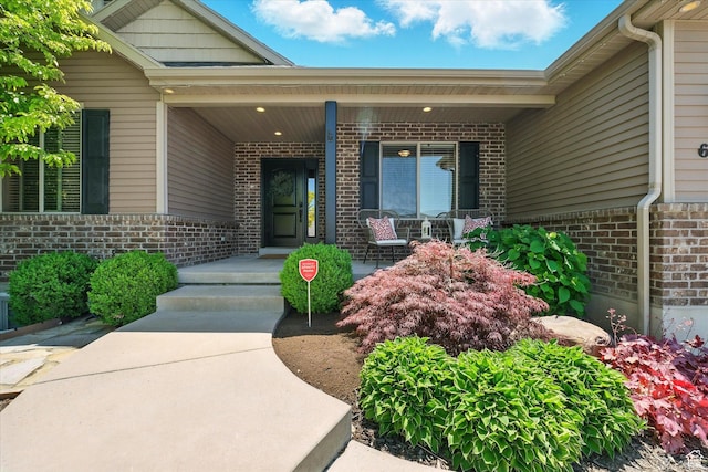 674 S 150 W, Hyde Park, UT 84318 - view of exterior entry with brick siding and a porch