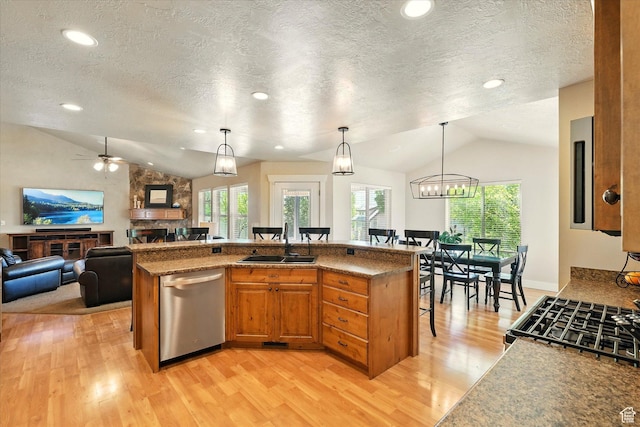 674 S 150 W, Hyde Park, UT 84318 - kitchen with lofted ceiling, a sink, dishwasher, a kitchen bar, and light wood-style floors