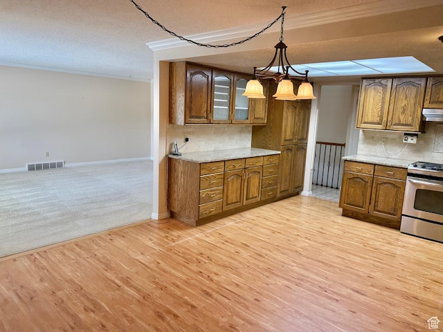 5253 S 2150 W, Roy, UT 84067 - kitchen featuring stainless steel range oven, crown molding, brown cabinets, a textured ceiling, and light wood finished floors