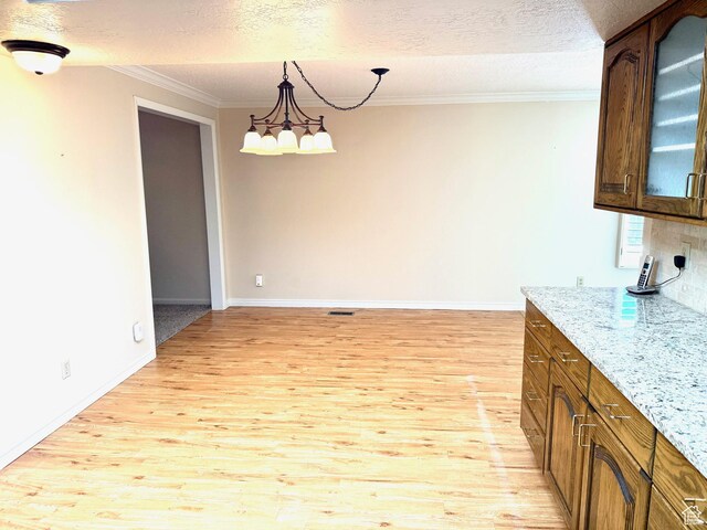 5253 S 2150 W, Roy, UT 84067 - kitchen featuring light wood-type flooring, crown molding, glass insert cabinets, a textured ceiling, and baseboards