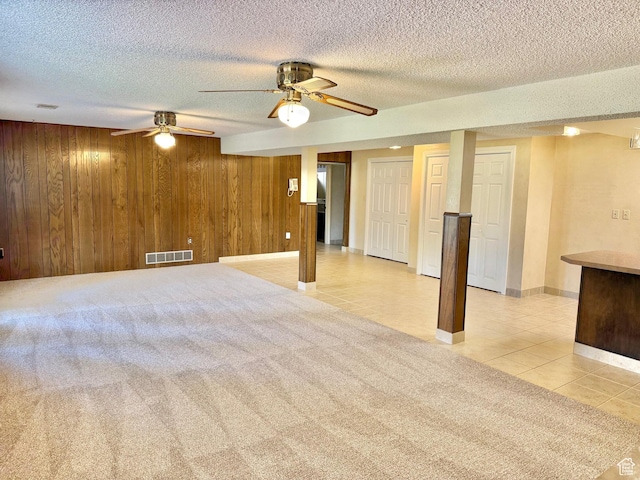 5253 S 2150 W, Roy, UT 84067 - finished below grade area featuring light tile patterned floors, a textured ceiling, wood walls, ceiling fan, and baseboards