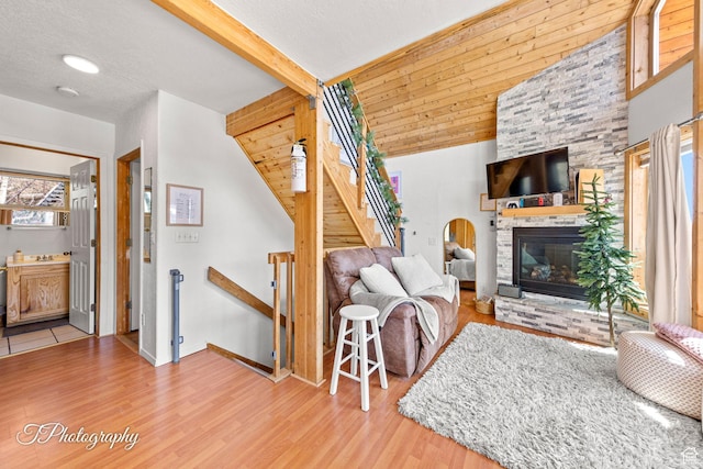 332 W Pinehurst Dr, Brian Head, UT 84719 - living room featuring wood finished floors, a stone fireplace, and baseboards