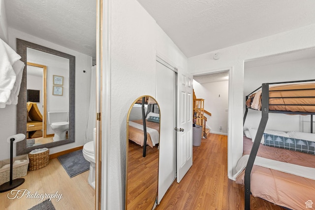 332 W Pinehurst Dr, Brian Head, UT 84719 - bedroom featuring wood finished floors, a textured ceiling, and a closet