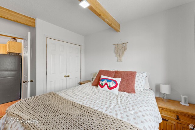 332 W Pinehurst Dr, Brian Head, UT 84719 - bedroom with freestanding refrigerator, beam ceiling, and a closet