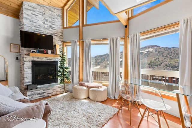 332 W Pinehurst Dr, Brian Head, UT 84719 - living area with wood finished floors, a stone fireplace, beam ceiling, and high vaulted ceiling