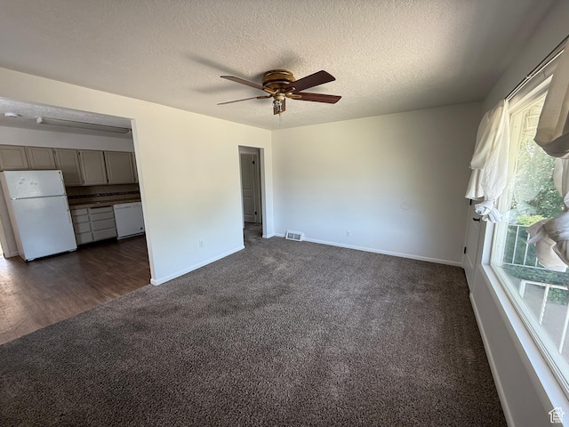 2168 S Harrison Blvd, Ogden, UT 84401 - unfurnished living room featuring dark carpet, ceiling fan, baseboards, and a textured ceiling