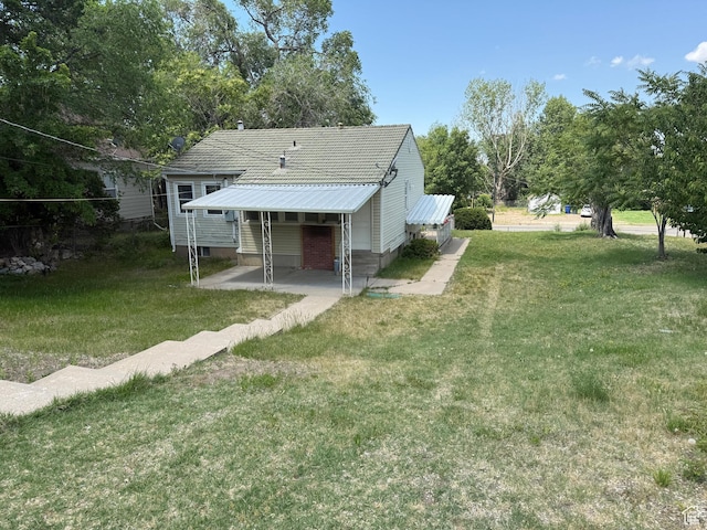 2168 S Harrison Blvd, Ogden, UT 84401 - rear view of house featuring a yard and entry steps