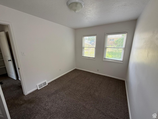 2168 S Harrison Blvd, Ogden, UT 84401 - empty room featuring dark carpet, a textured ceiling, and baseboards