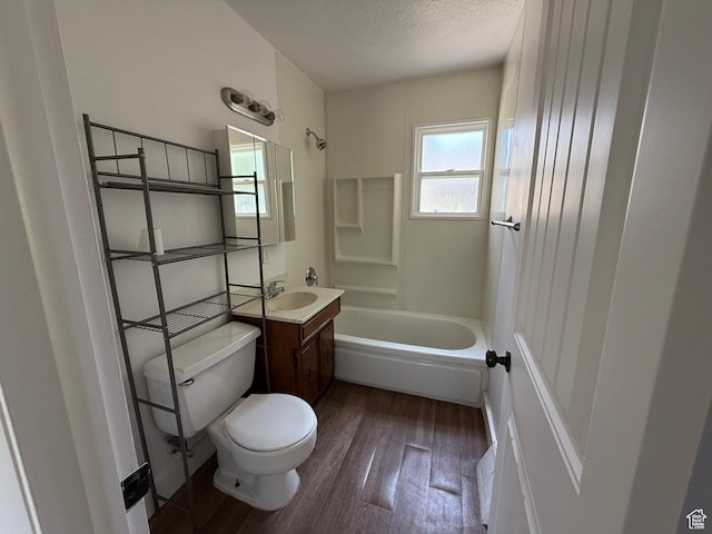 2168 S Harrison Blvd, Ogden, UT 84401 - bathroom featuring toilet, wood finished floors, vanity, shower / bathtub combination, and a textured ceiling
