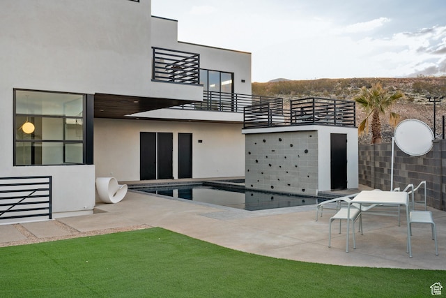 3147 S Mesa Verde Cir, Hurricane, UT 84737 - rear view of house featuring a balcony, a patio area, and stucco siding