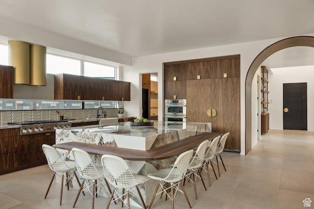 3147 S Mesa Verde Cir, Hurricane, UT 84737 - kitchen featuring appliances with stainless steel finishes, arched walkways, tasteful backsplash, and a sink