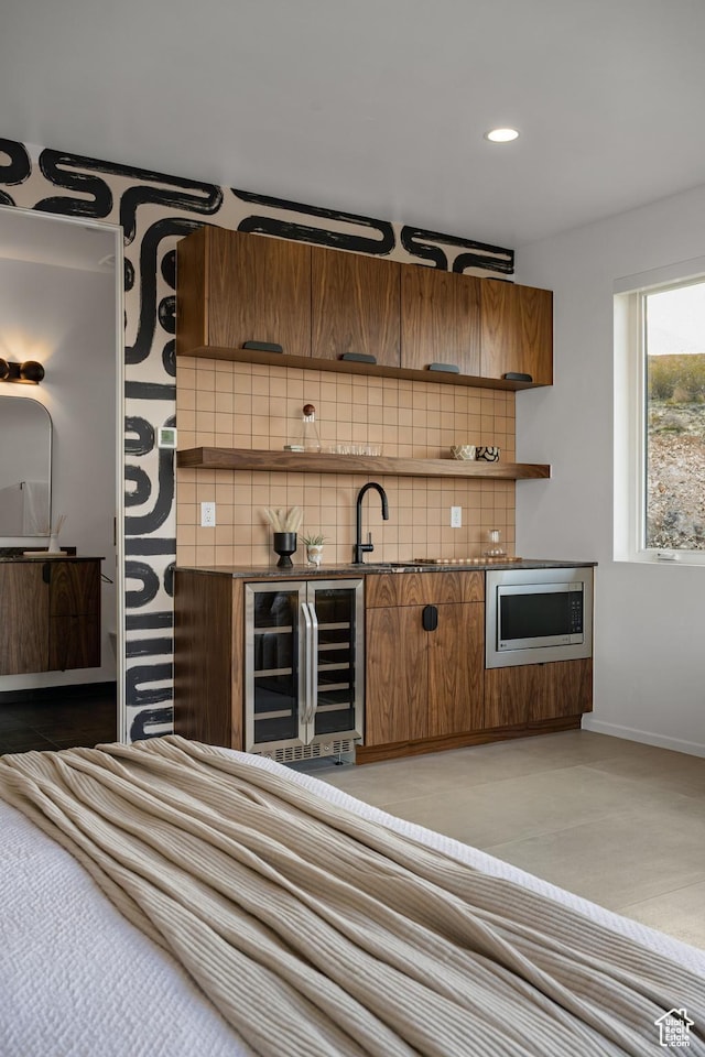 3147 S Mesa Verde Cir, Hurricane, UT 84737 - indoor wet bar with beverage cooler, tasteful backsplash, stainless steel microwave, baseboards, and recessed lighting