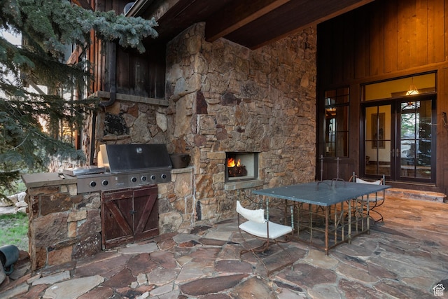 7701 N W Hills Trl, Park City, UT 84098 - view of patio featuring a lit fireplace and outdoor dining space
