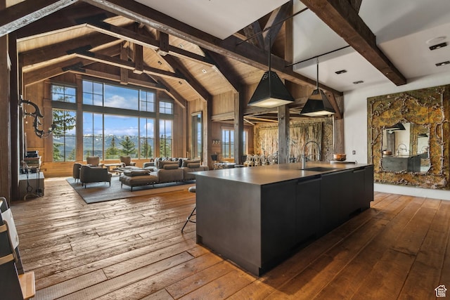 7701 N W Hills Trl, Park City, UT 84098 - kitchen featuring a sink, dark wood-style flooring, beam ceiling, an island with sink, and high vaulted ceiling