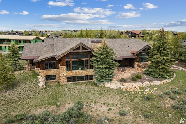 7701 N W Hills Trl, Park City, UT 84098 - rear view of house featuring stone siding and a shingled roof