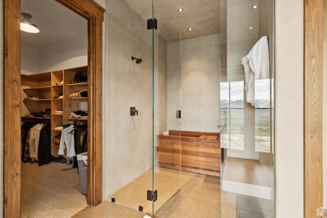 7701 N W Hills Trl, Park City, UT 84098 - full bath with a shower stall, a walk in closet, and tile patterned floors
