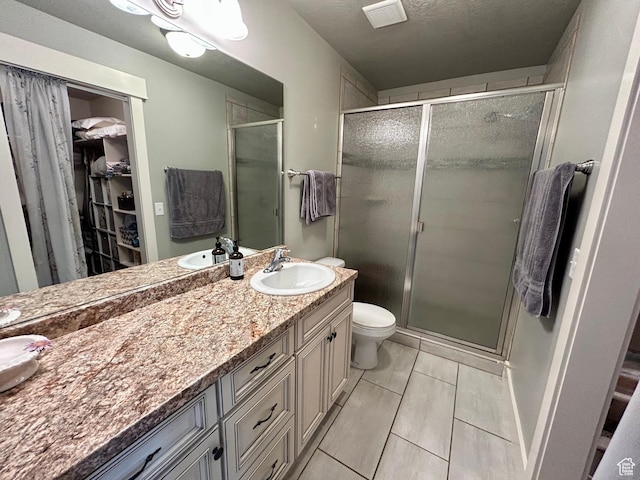 319 S 600 E, Payson, UT 84651 - full bathroom featuring vanity, a walk in closet, a shower stall, and toilet