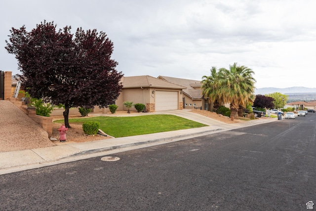 1500 E Mesa View Ln, Washington, UT 84780 - view of front facade featuring a garage, stucco siding, a tiled roof, driveway, and a front yard