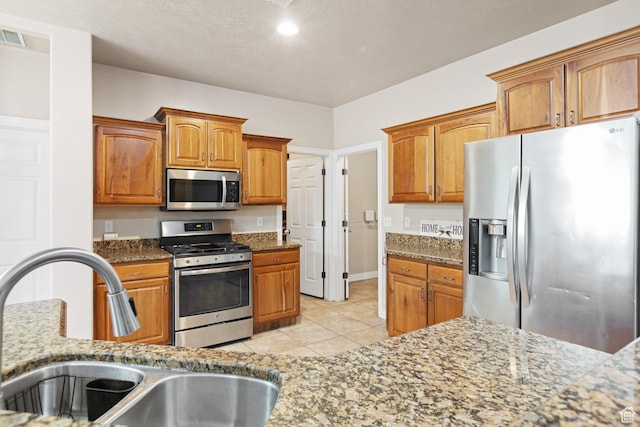 1500 E Mesa View Ln, Washington, UT 84780 - kitchen with appliances with stainless steel finishes, a sink, light tile patterned floors, and stone countertops