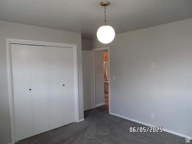 288 W 775 N, Logan, UT 84321 - unfurnished bedroom with dark colored carpet, a closet, and baseboards