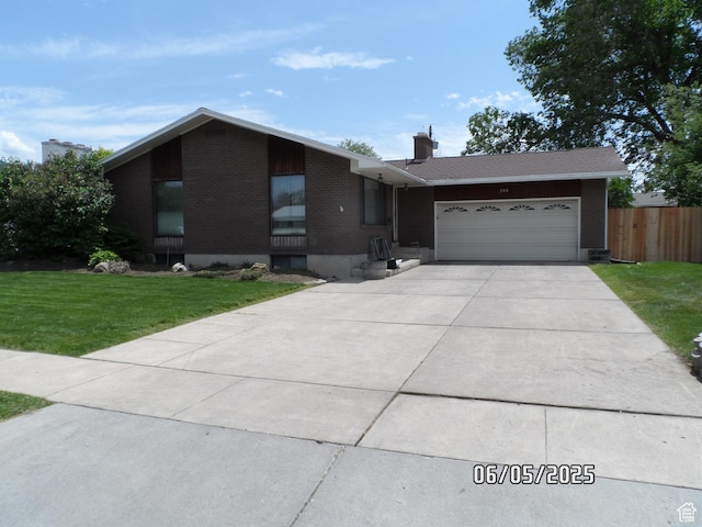 288 W 775 N, Logan, UT 84321 - view of front facade with brick siding, an attached garage, driveway, and a chimney