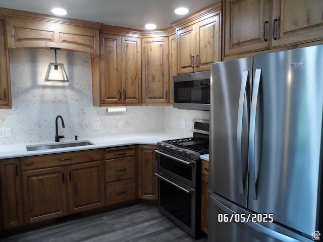 288 W 775 N, Logan, UT 84321 - kitchen featuring stainless steel appliances, a sink, decorative backsplash, dark wood-style flooring, and recessed lighting