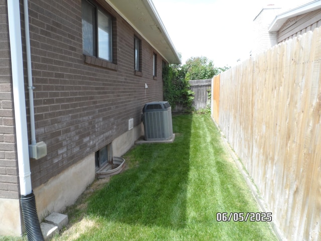 288 W 775 N, Logan, UT 84321 - view of side of home with cooling unit and brick siding