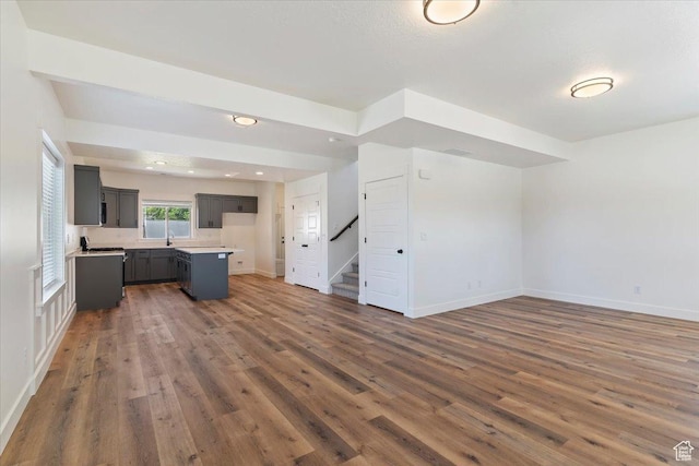 874 Cahoon St, Ogden, UT 84401 - unfurnished living room with wood finished floors, stairs, a sink, and baseboards