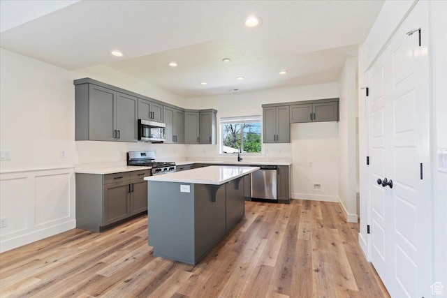 874 Cahoon St, Ogden, UT 84401 - kitchen with stainless steel appliances, gray cabinetry, a center island, light wood-style floors, and recessed lighting
