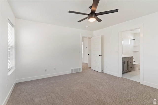 874 Cahoon St, Ogden, UT 84401 - unfurnished bedroom featuring light colored carpet, baseboards, ensuite bath, and a ceiling fan
