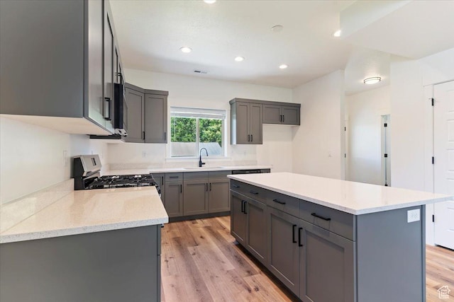 874 Cahoon St, Ogden, UT 84401 - kitchen featuring gray cabinetry, stainless steel gas range, light wood-style flooring, recessed lighting, and a sink