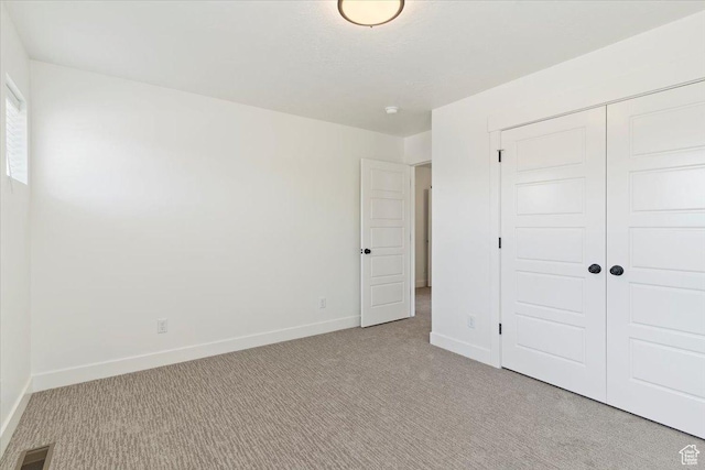 874 Cahoon St, Ogden, UT 84401 - unfurnished bedroom with light colored carpet, a closet, and baseboards