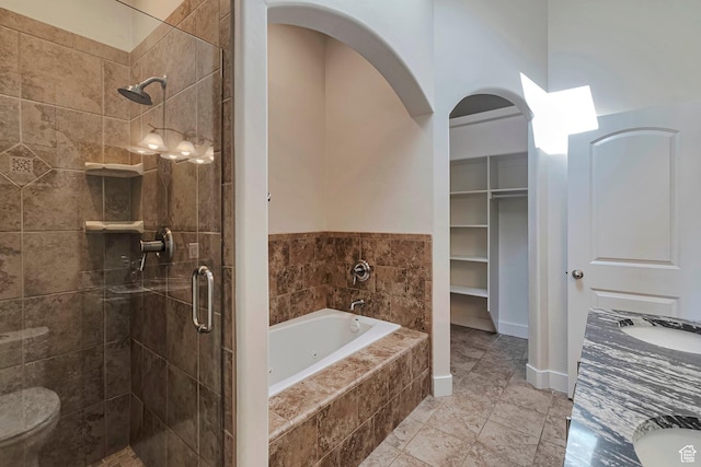 222 E 905 N, Orem, UT 84057 - bathroom with a stall shower, a jetted tub, double vanity, tile patterned floors, and a walk in closet
