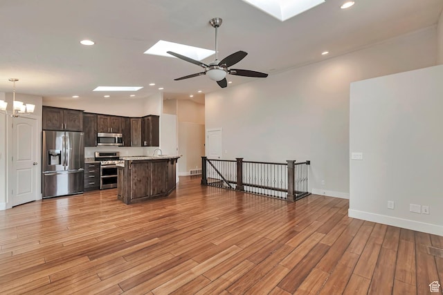 222 E 905 N, Orem, UT 84057 - kitchen with stainless steel appliances, a skylight, dark brown cabinets, light countertops, and recessed lighting