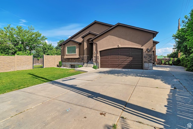 222 E 905 N, Orem, UT 84057 - view of front of home featuring stone siding, stucco siding, a gate, a garage, and driveway