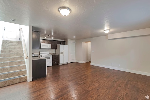222 E 905 N, Orem, UT 84057 - kitchen with white appliances, dark wood-style floors, baseboards, open floor plan, and dark brown cabinetry