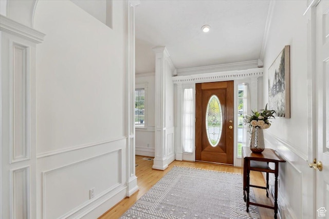 595 E 100 S, Morgan, UT 84050 - entrance foyer with a decorative wall, crown molding, light wood-style flooring, ornate columns, and a wainscoted wall