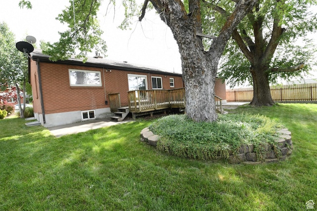 145 E 100 S, Farmington, UT 84025 - rear view of house with a deck, a patio area, and brick siding